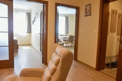 a living room with a couch and a table at Trimaya apartment - comfort in the top city center in Varna City