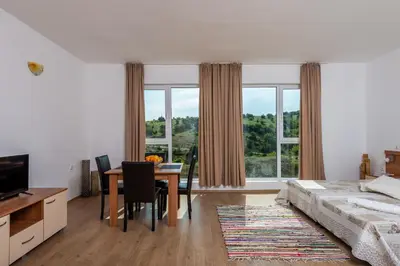 a bedroom with a table and a bed and a dining room at Villa Entre in Emona