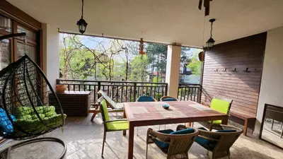 a room with a table and chairs on a balcony at Nevena Summer Apartment by Santa Marina Sozopol in Sozopol