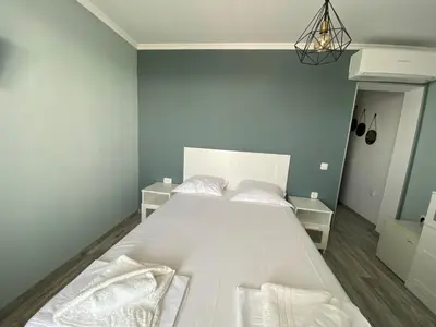 a bedroom with a white bed with white sheets and pillows at Your Room Primorsko in Primorsko