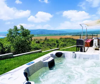 a hot tub in the grass with a view at Villa Meraki in Byala