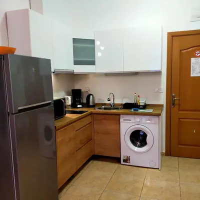 a kitchen with a washing machine and a washer at Trakia Plaza Apartament Sunny Beach in Sunny Beach