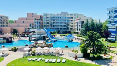 a large pool with a slide in a resort at Trakia Plaza Apartament Sunny Beach in Sunny Beach