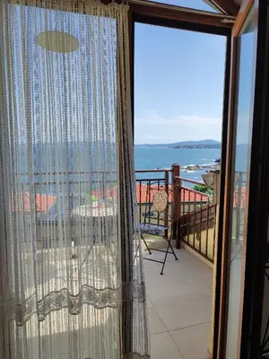 a balcony with a view of the ocean at Созополски Рай in Sozopol