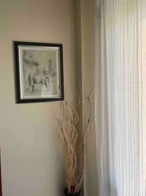 a picture hanging on a wall next to a window at Nessebar panoramic apartment in Nesebar