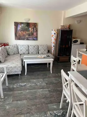 a living room with a couch and a table at Nessebar panoramic apartment in Nesebar