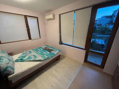 a small bedroom with a bed and a window at Vqra Sarafovo in Burgas City