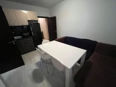 a living room with a white table and a couch at Vqra Sarafovo in Burgas City