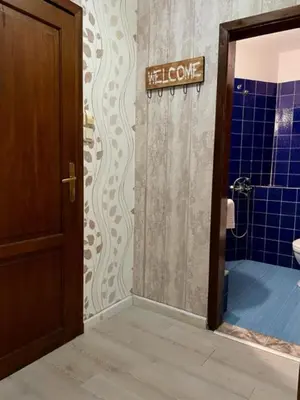 a bathroom with a shower and a sign that says welcome at Apart Zefira 2 Rooms in Varna City