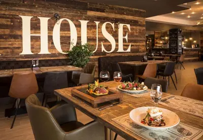 a restaurant with a table with food and wine glasses at Апартамент Б306 в Обзор Бийч Резорт на първа линия с перфектен изглед към плажа! in Obzor