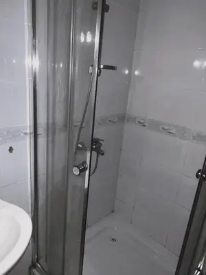 a shower with a glass door next to a sink at Residence Livi Paradise Sunny Beach! 2 plus 1 - 600m away from the beach in Sunny Beach