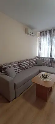 a living room with a couch and a coffee table at Чудесно място с басейн 