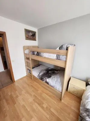 two bunk beds in a room with a wooden floor at Modern 1 Bed Apt, Nesebar Fort in Sunny Beach