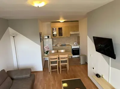 a living room with a couch and a kitchen at Modern 1 Bed Apt, Nesebar Fort in Sunny Beach