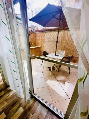 a view of a balcony with a blue umbrella at Green Central Apartment in Varna City
