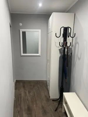 a room with a white wall and a door withweapons at Studio flat in the heart of Burgas in Burgas City